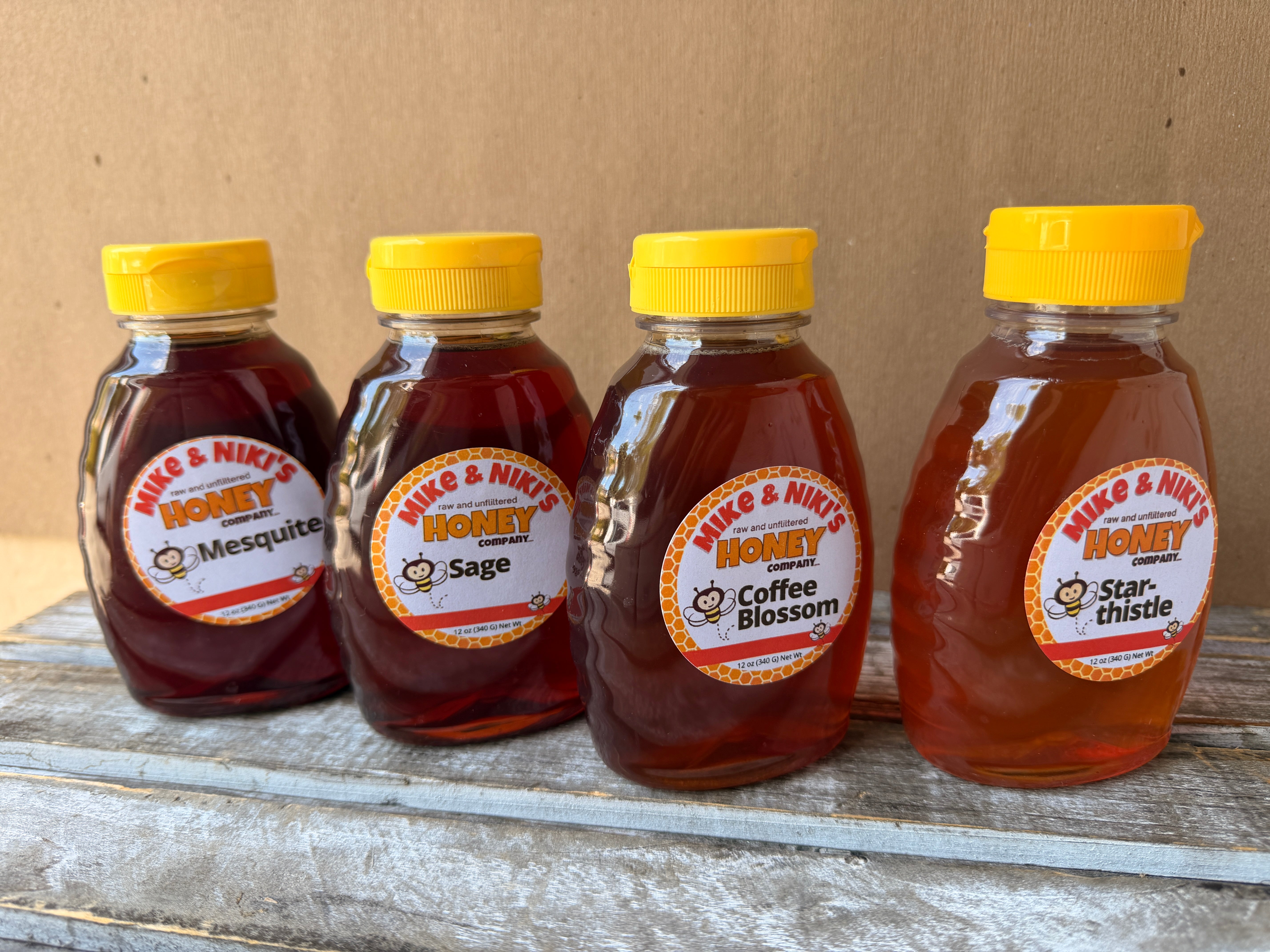 Mike & Niki's Honey Company 12 oz honey lineup - Sage, Mesquite, Coffee Blossom, and Star-thistle squeeze bottles